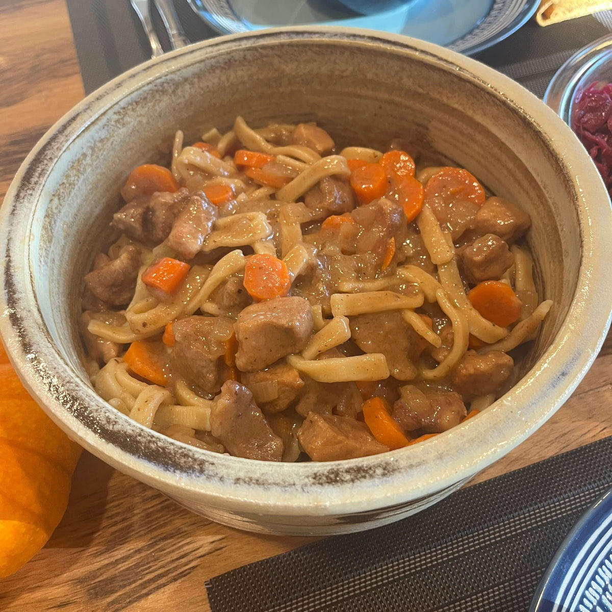 Pork cooked in apple cider over egg noodles.