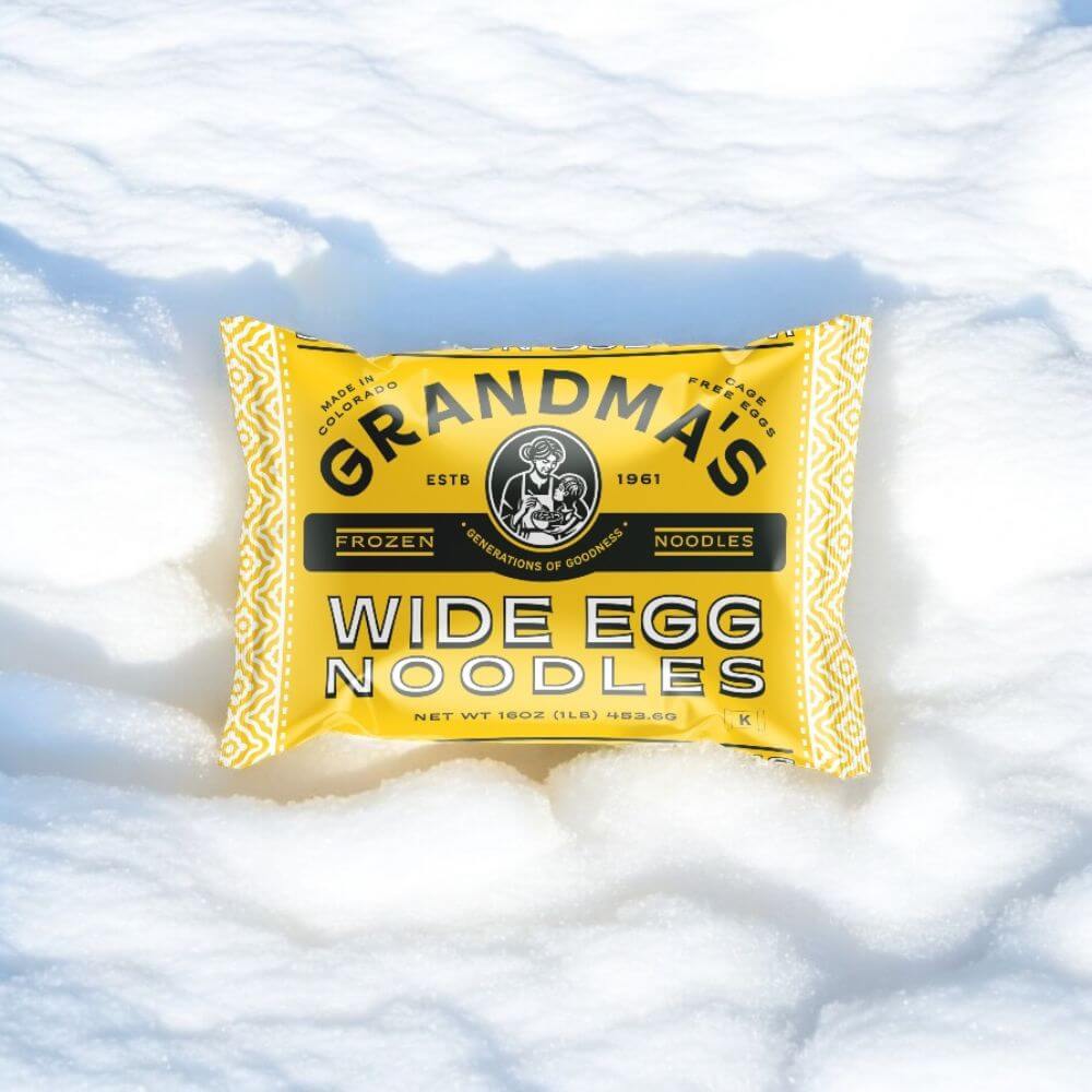 Package of Grandma's Frozen Egg Noodles sitting in snow.