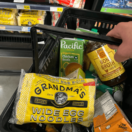 Grandma's frozen egg noodles in a shopping cart with broth.