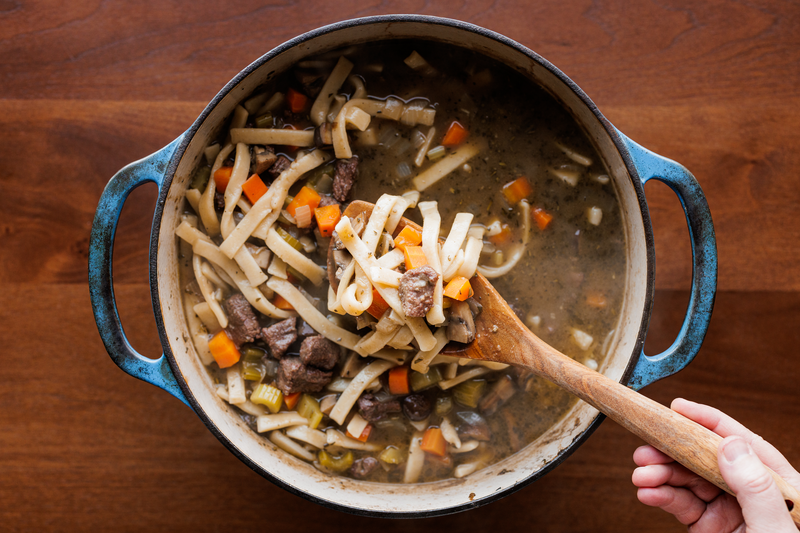Grandma's egg noodles in large stew pot cooking.